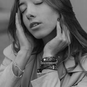 Serene face of a person meditating in the dark.